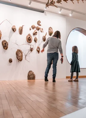 Une maman montre à sa fille une exposition d'art